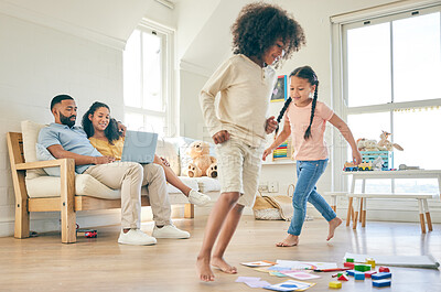 Buy stock photo Big family, toys and children running with parents on a laptop 
in lounge at home together for creative fun. Living room, happy and development of kids on carpet floor with games by mom and dad