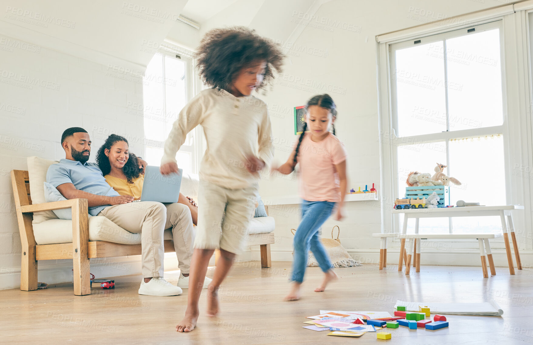 Buy stock photo Family, toys and children running in a home with parents streaming on a laptop in lounge together for creative fun. Living room, happy and development of kids playing with games by mom and dad