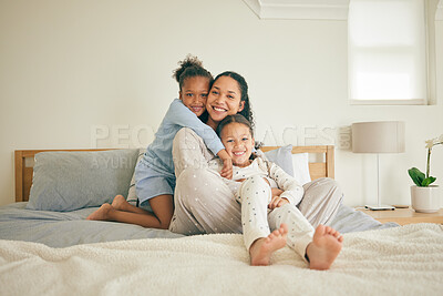 Buy stock photo Mom, children and hug on bed, portrait and happy family home with love, care and bonding together. Young kids, mother and daughter with embrace, bedroom and relax in pyjamas with smile in apartment