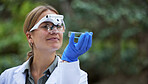 Science, analysis and woman with petri dish in forest, study growth of trees and sustainable plants in nature. Ecology, safety and research in biology, scientist with glasses and inspection in woods.