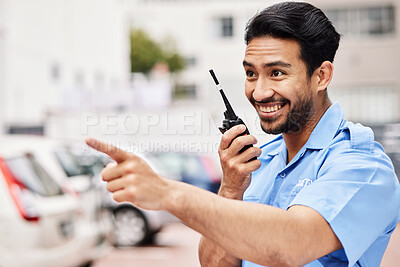 Buy stock photo Happy, pointing and security with a walkie talkie in the city for communication on parking lot safety. Smile, thinking and an Asian worker with gear for talking and a warning in town for work