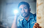 Flashlight, security guard and man in dark room for investigation, inspection and property search at night. Surveillance, law and police male person looking for safety, crime and protection service