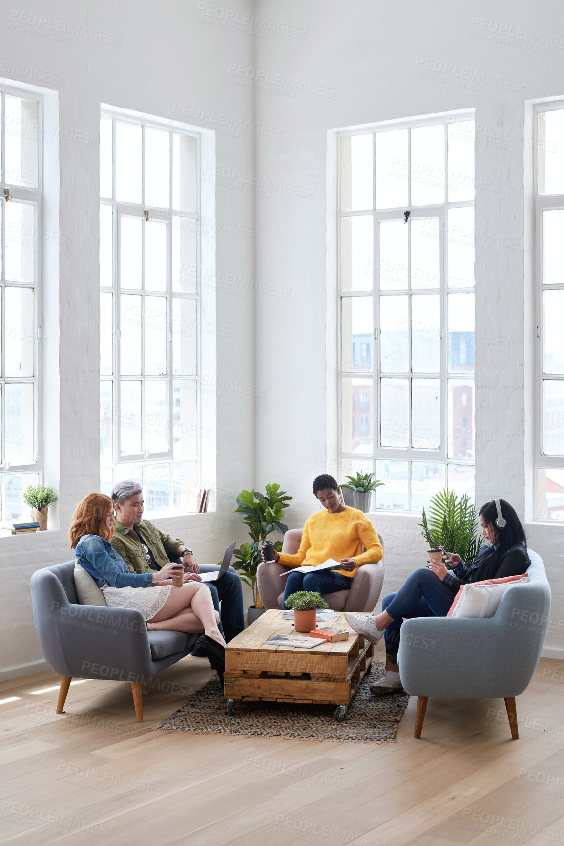Buy stock photo Startup, meeting and creative employees in the office lounge or coworking space planning a project in collaboration. Teamwork, diversity and team working together with technology on sofa in workplace