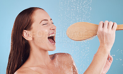 Buy stock photo Happy woman, shower and singing with brush for hygiene, cleaning or self love and body care against a blue studio background. Female person enjoying water, rain or wash for cleanliness or grooming