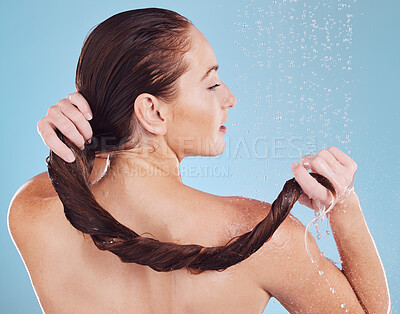 Buy stock photo Woman, washing hair in shower and back view, hygiene and water drops isolated on blue background. Grooming, cosmetic care and sustainability, female person and morning routine, shampoo and haircare