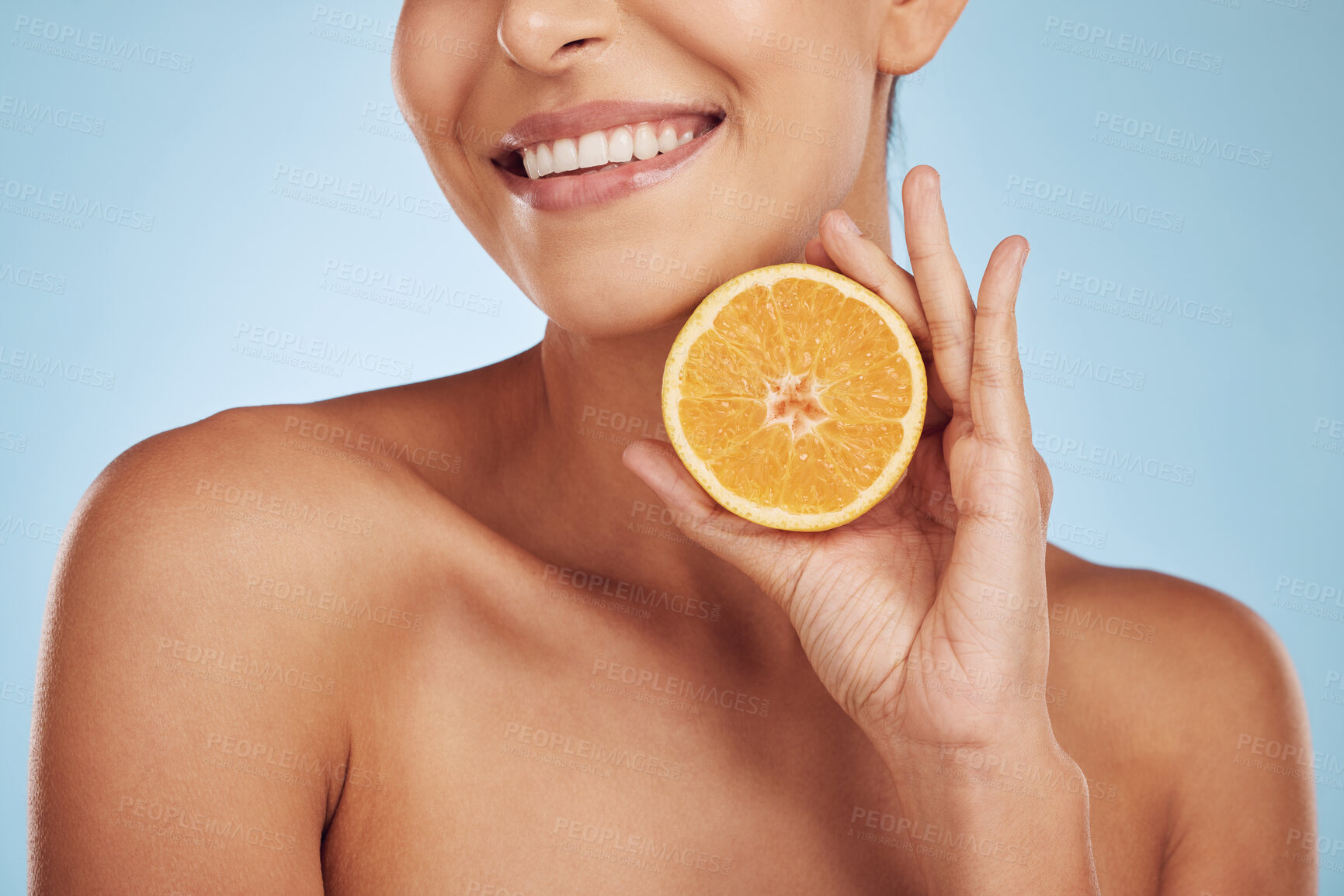 Buy stock photo Happy woman, hands and orange for natural vitamin C, skincare or diet against a blue studio background. Closeup of person smile with organic citrus fruit in nutrition, dermatology or healthy wellness