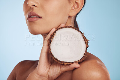 Buy stock photo Woman, coconut fruit and beauty, skincare or vegan cream isolated studio, blue background. Model or person hands with natural product for dermatology, eco friendly cosmetics and oil benefits