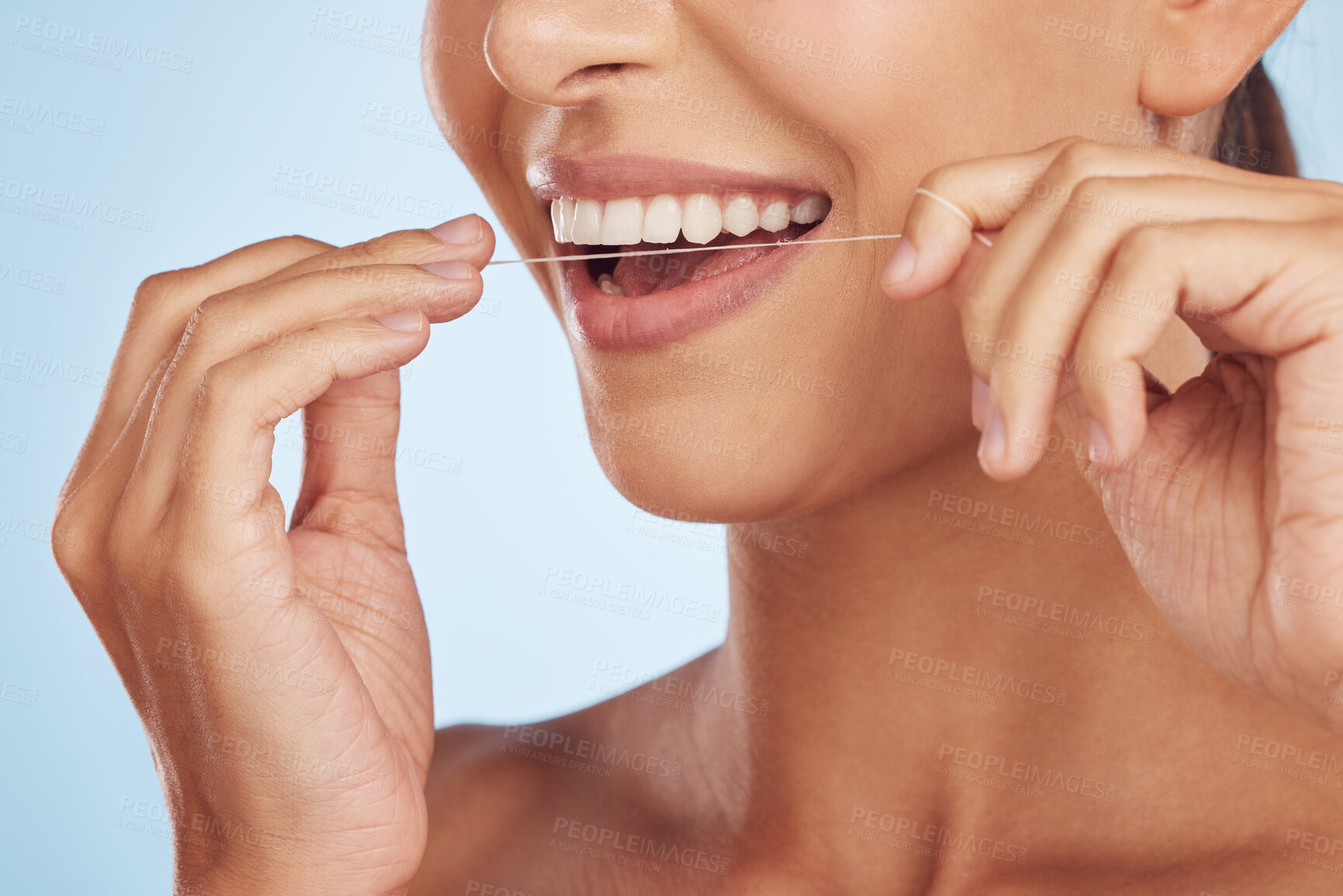 Buy stock photo Teeth, flossing and woman with dental and hands, hygiene and grooming with oral care isolated on blue background. Closeup of female model cleaning mouth, health and morning routine and prevent cavity