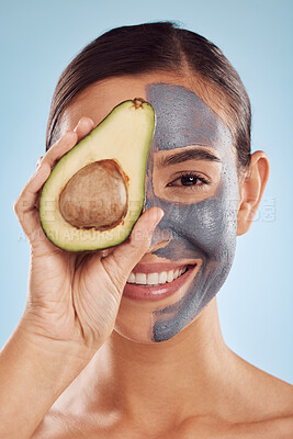 Buy stock photo Woman, avocado and face mask for natural skincare, beauty and vitamin d benefits on studio blue background. Portrait of person or model in charcoal facial, green fruits and skin care for dermatology