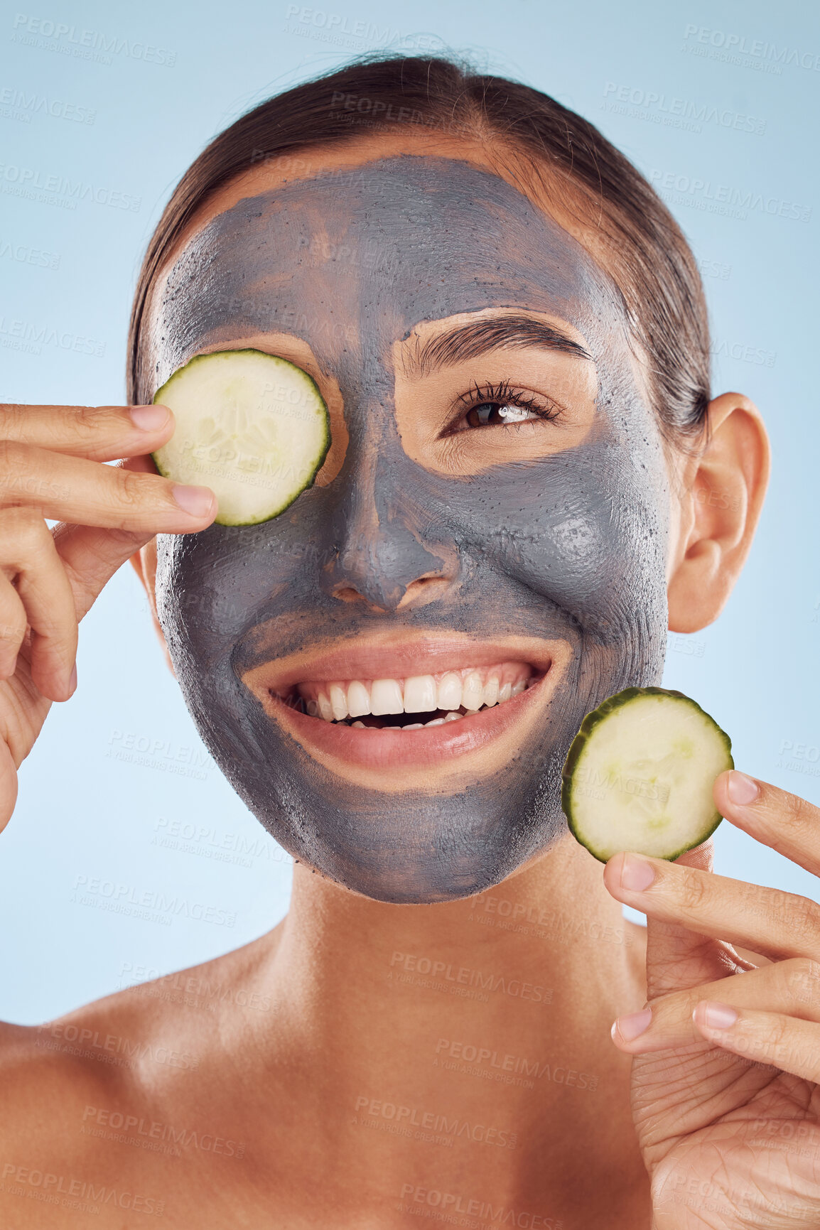 Buy stock photo Smile, cucumber and mask for beauty with a woman in studio on a blue background for antiaging skincare. Face, thinking and antioxidants with an attractive young female person posing for treatment