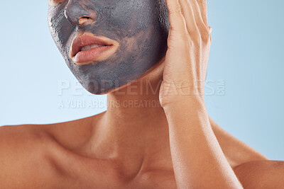 Buy stock photo Face mask, charcoal and beauty of woman with cosmetic facial treatment isolated in a blue studio background. Skin, skincare and young female person with clean, hydration and dermatology cream