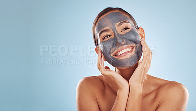 Buy stock photo Woman, face mask and thinking of charcoal skincare, natural beauty and cosmetics benefits on studio, blue background. Ideas of person or model for facial collagen, skin care and dermatology on banner