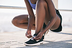 Hands, city and runner tie shoes to start workout, training or exercise outdoor. Sports, fitness and athlete tying laces on sneakers to prepare for cardio, running and jog for health and wellness