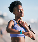 Fitness, wellness and athlete checking her pulse with smartwatch for running outdoor in nature. Sports, workout and African woman monitoring her heart rate for cardio training for race or marathon.