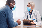 Woman, doctor and clipboard for consultation with patient, checkup or life insurance on desk at hospital. Female person, medical or healthcare expert with face mask consulting customer at the clinic