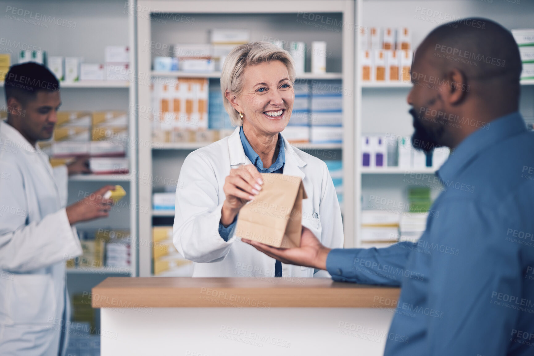 Buy stock photo Happy woman, pharmacist and paper bag for patient, healthcare or medication at the pharmacy. Female person or medical professional giving pills, drugs or pharmaceuticals product to customer at clinic