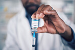 Closeup of hand, doctor and vaccine, injection and container with medicine, healthcare and safety from virus. Person, liquid drugs and syringe with glass vial or bottle, pharmaceutical and health