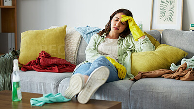 Buy stock photo Stress, headache and woman with anxiety for laundry, clothes or overwhelmed by cleaning on sofa. Housework, depression migraine after washing, pile or chaos at home with vertigo or brain fog