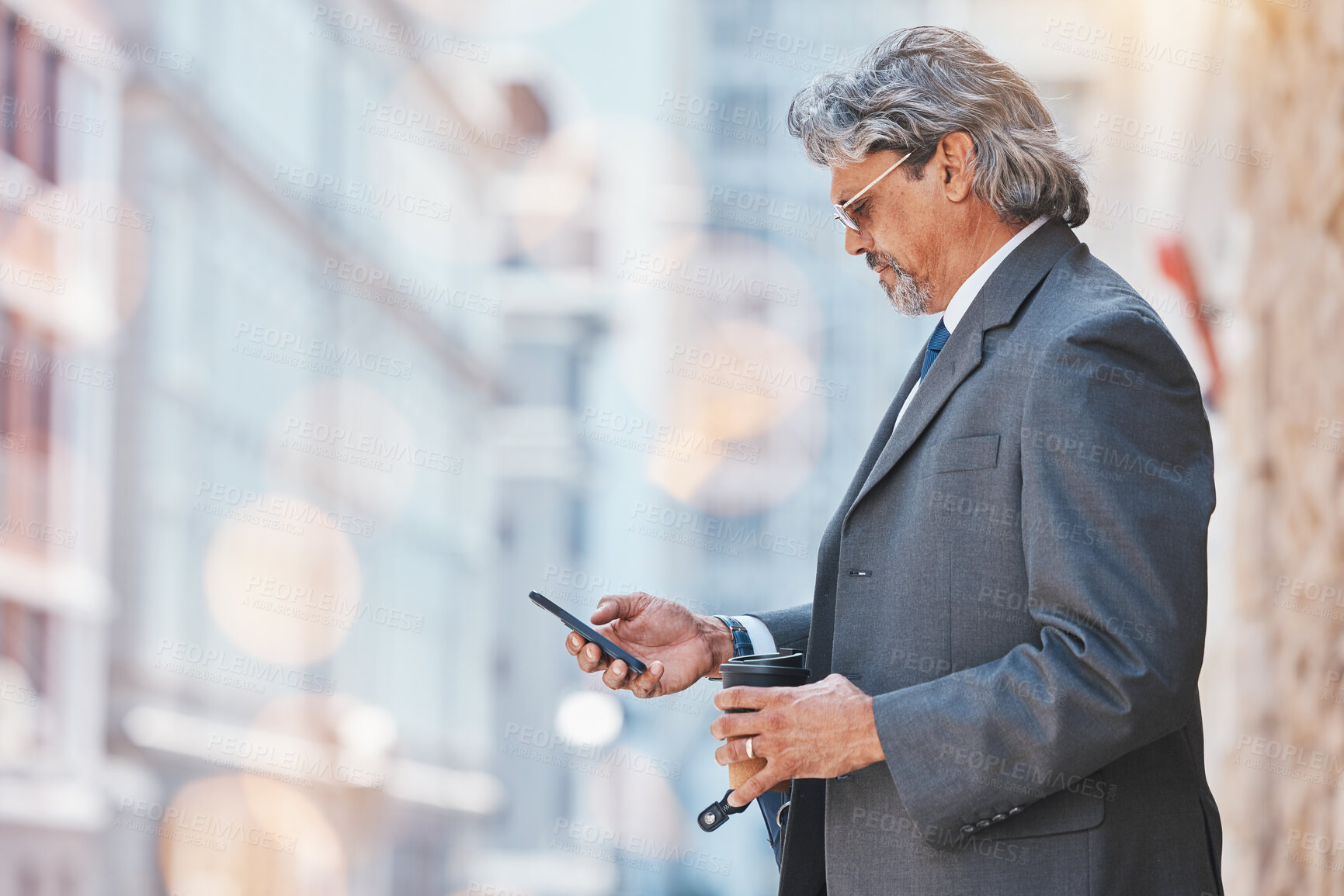 Buy stock photo Senior, business man and cellphone in city, travel and commute, bokeh and communication outdoor. Mexican male executive, CEO using phone to chat on journey to work and urban street with mockup space