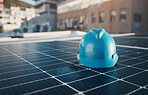 Construction, building and a hat for solar panel on a roof for engineering or a sustainability job. Future, innovation and a helmet on a power development for a home, maintenance or renewable energy