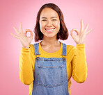 Smile, okay and yes with portrait of woman in studio for support, agreement and motivation. Winner, emoji and success with face of person on pink background for achievement, thank you and vote sign