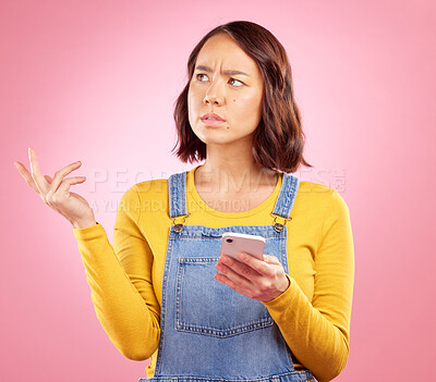 Buy stock photo Confused, studio and Asian woman with smartphone problem, 404 fail and stress over mistake, error or ideas. Thinking, doubt and Japanese person frustrated over online phone glitch on pink background