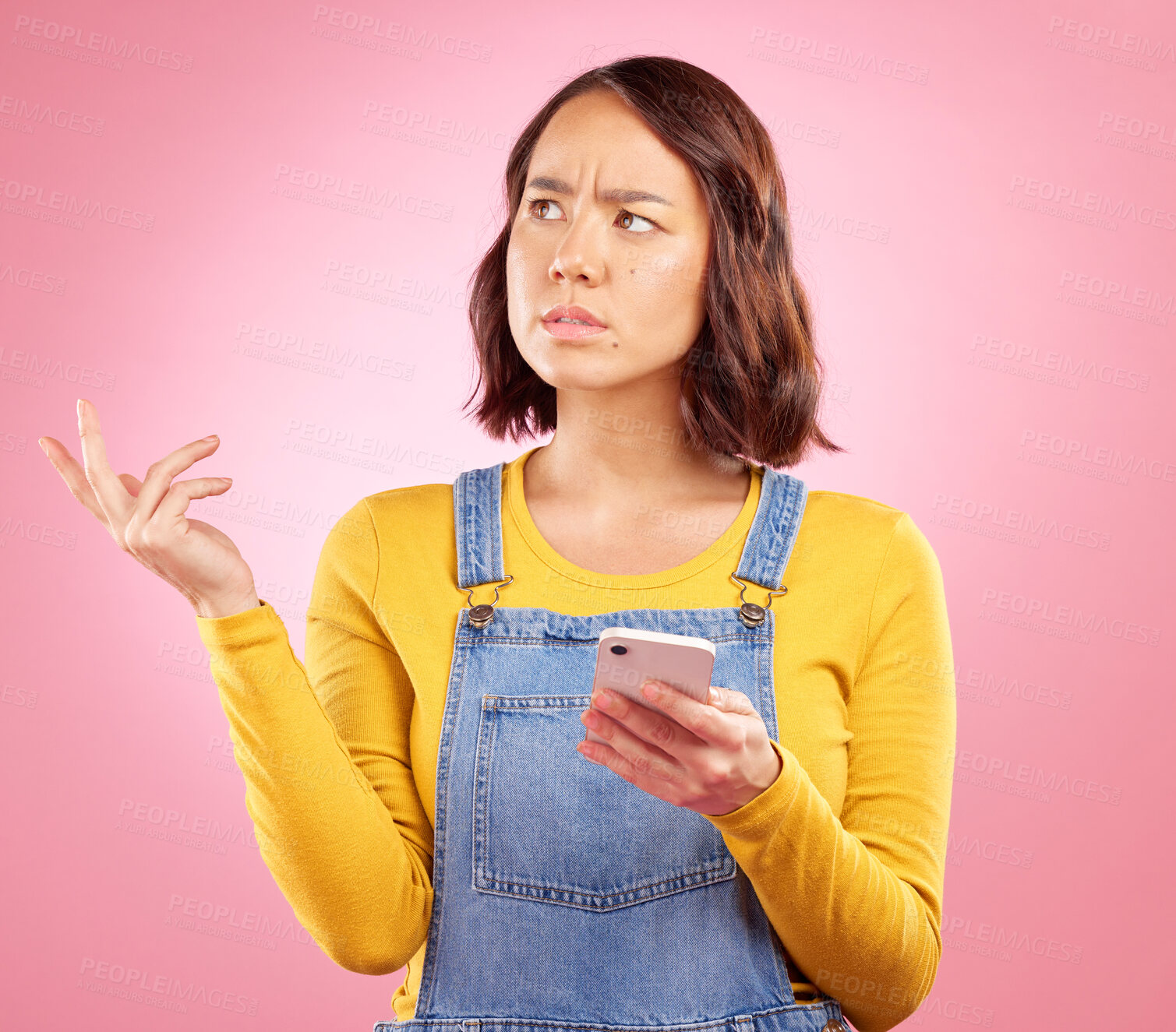 Buy stock photo Confused, studio and Asian woman with smartphone problem, 404 fail and stress over mistake, error or ideas. Thinking, doubt and Japanese person frustrated over online phone glitch on pink background