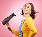 Hairdryer, smile and hair care with portrait of woman in studio for hairdresser, beauty and cosmetics. Shampoo, salon and hairstyle with face of person on pink background for product and glow