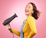 Hairdryer, laugh and hair care with portrait of woman in studio for hairdresser, beauty and cosmetics. Shampoo, smile and hairstyle with face of person on pink background for product, salon and glow