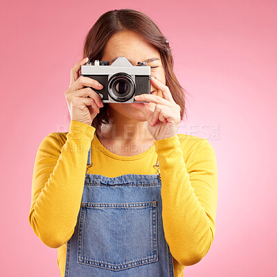 Buy stock photo Photographer woman, retro camera and studio for shooting, memory or paparazzi job by pink background. Journalist girl, photoshoot and lens for newspaper, gossip magazine or content creator for blog