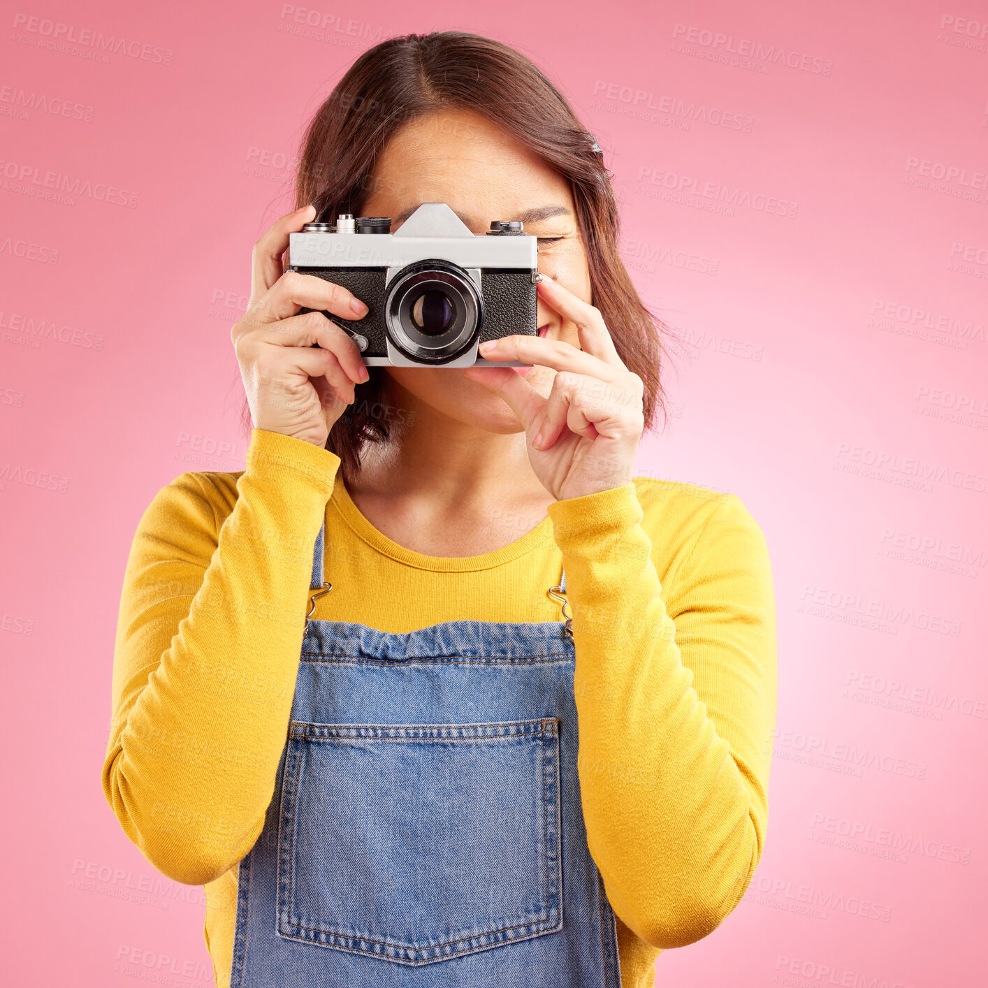 Buy stock photo Photographer woman, retro camera and studio for shooting, memory or paparazzi job by pink background. Journalist girl, photoshoot and lens for newspaper, gossip magazine or content creator for blog