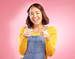 Smile, thumbs up and happy with portrait of woman in studio for support, agreement and motivation. Winner, emoji and success with person on pink background for achievement, thank you and vote sign