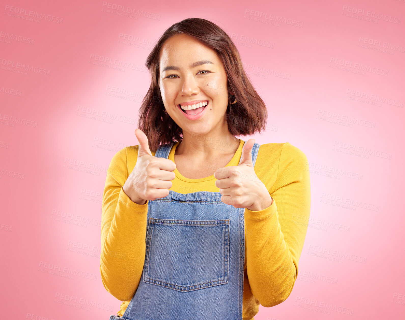 Buy stock photo Smile, thumbs up and happy with portrait of woman in studio for support, agreement and motivation. Winner, emoji and success with person on pink background for achievement, thank you and vote sign