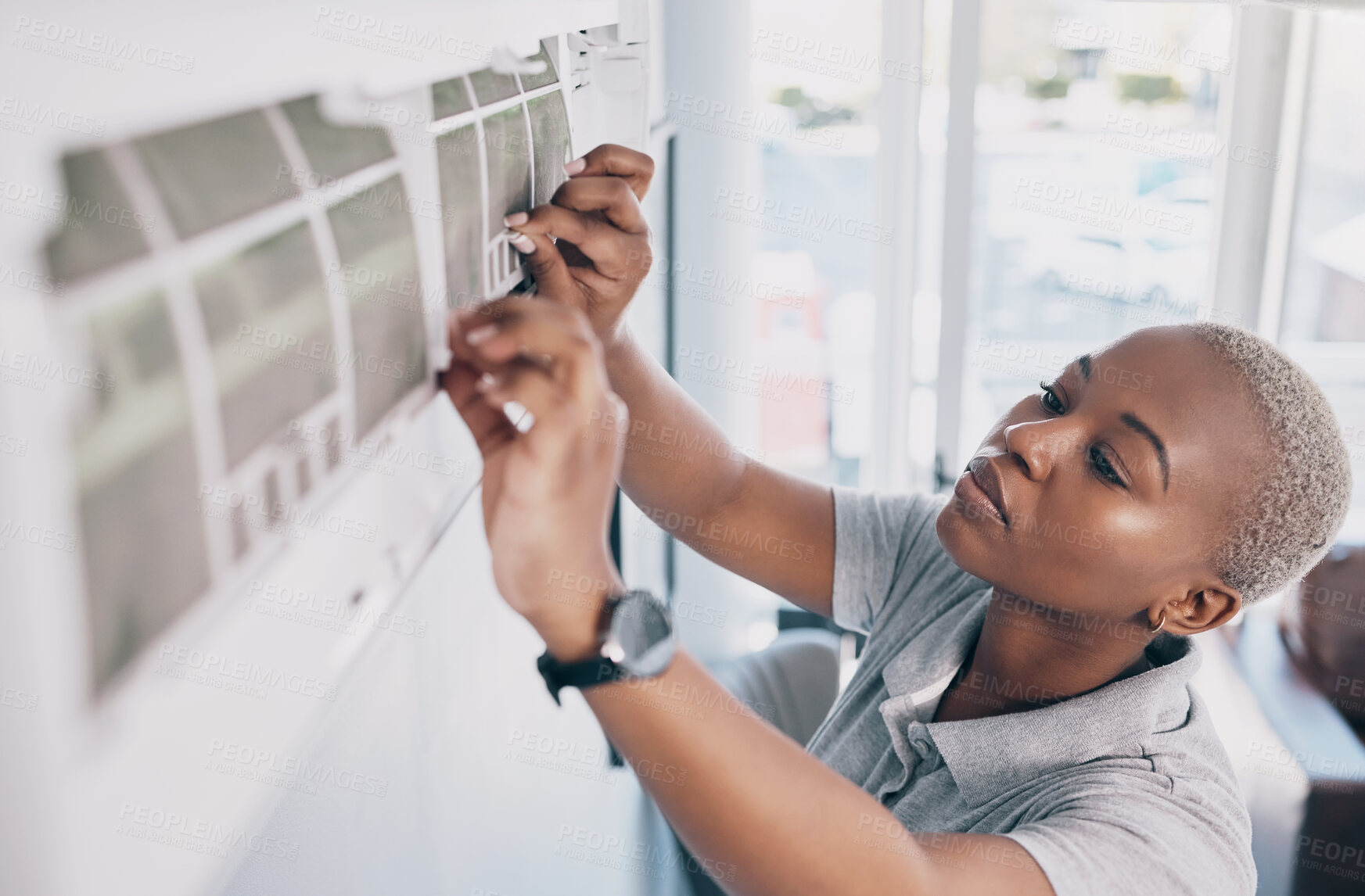 Buy stock photo Black woman, electrician and ac repair for electrical system, fan maintenance and labor. Female mechanic, technician and engineering to fix aircon power, hvac services and air conditioning machine