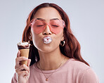 Kiss, ice cream and face of woman with sunglasses in studio with dessert, snack and sweet treats. Kissing emoji, fashion and female person with gelato cone in trendy accessories, style and cosmetics