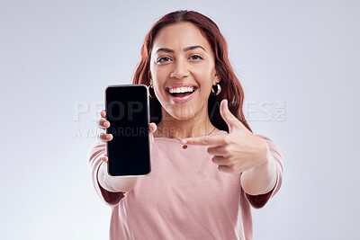 Buy stock photo Happy woman is pointing at phone screen, mockup and marketing, mobile app ads on white background. Website promo, advertising and female ambassador in portrait with social media branding in studio