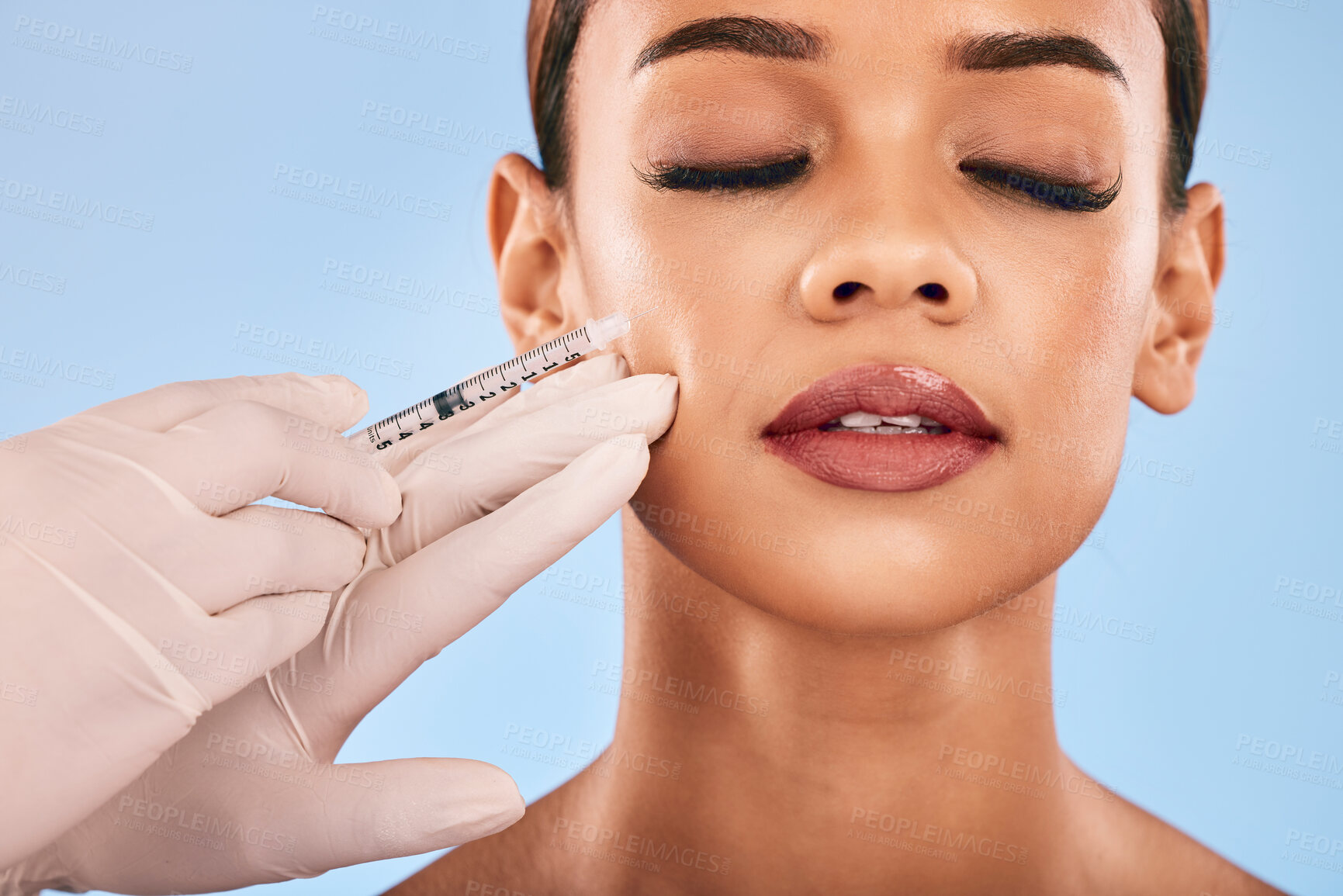 Buy stock photo Face, injection and beauty, woman and cosmetic surgery  and dermatology isolated on blue background. Antiaging, skincare and syringe, female model and doctor hands with liquid collagen in studio