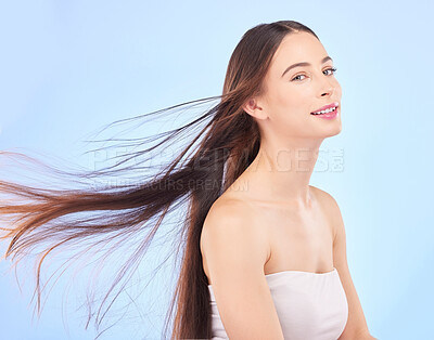 Buy stock photo Portrait, hair and beauty with a model woman in studio on a blue background for shampoo or keratin treatment. Spa, salon or hairdresser with an attractive young female person posing for haircare