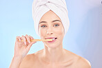 Beauty, dental and brushing teeth with portrait of woman in studio for wellness, self care and skincare. Product, shower and cleaning with person on blue background for cosmetics and oral hygiene