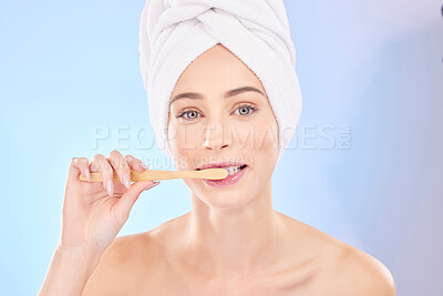 Buy stock photo Beauty, dental and brushing teeth with portrait of woman in studio for wellness, self care and skincare. Product, shower and cleaning with person on blue background for cosmetics and oral hygiene