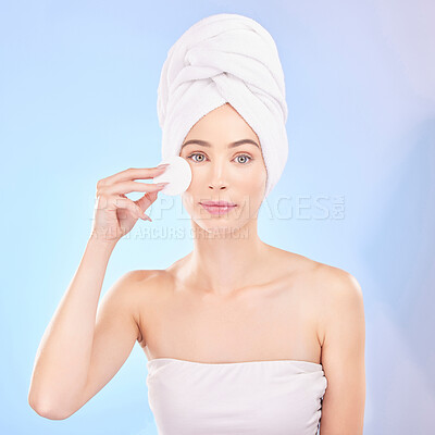 Buy stock photo Skincare, face pad and portrait of woman in studio for a natural, self care and spa routine. Beauty, health and young female model from Australia with clean skin treatment isolated by blue background