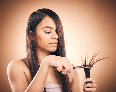 Buy stock photo Woman, hair care and scissors in studio to cut split ends for a healthy shine and growth. Young female aesthetic model on a brown background for self care, cosmetics and beauty with salon tools