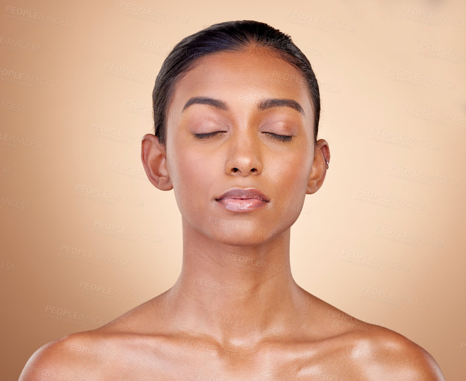 Buy stock photo Skincare, beauty and Indian woman with cosmetics, facial and dermatology against a brown studio background. Female person, aesthetic and model with treatment, bare and shine with glow and wellness