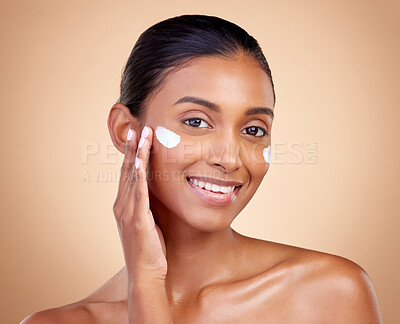 Buy stock photo Face, cream and portrait of indian woman, skincare cosmetics and aesthetic dermatology on studio background. Happy young female model, lotion and facial sunscreen for clean beauty, glow and self care