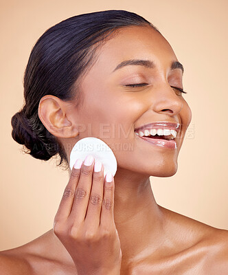 Buy stock photo Happy woman, cotton pad and skincare of face cosmetics, aesthetic wellness and studio background. Indian female model, clean beauty and facial cleaning product for makeup removal, dermatology or glow