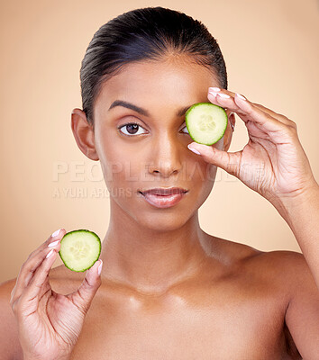 Buy stock photo Cucumber, skincare and portrait of woman in studio, background or aesthetic shine. Face of indian female model, natural beauty and cooling fruits for sustainable cosmetics, healthy dermatology or spa