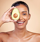 Avocado, skincare and portrait of happy woman in studio, background or aesthetic glow. Face of indian female model, natural beauty and fruit for sustainable cosmetics, healthy food or facial benefits