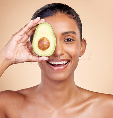 Buy stock photo Avocado, skincare and portrait of happy woman in studio, background or aesthetic glow. Face of indian female model, natural beauty and fruit for sustainable cosmetics, healthy food or facial benefits