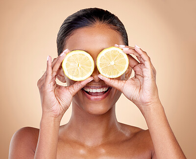 Buy stock photo Face, skincare or happy woman with lemon for health, wellness or vitality isolated on studio background. Girl, smile or female model with natural citrus fruit for vitamin c, minerals or nutrition 