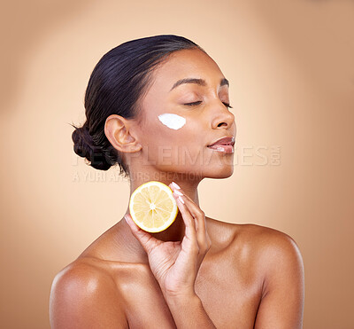 Buy stock photo Woman, lemon and cream for natural skincare, beauty product and cosmetics or vitamin c benefits and thinking. Person sleeping with face lotion, fruits and skin dermatology on brown, studio background